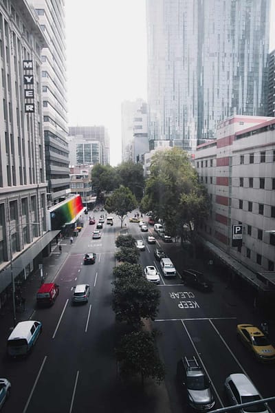 cars on road near buildings during daytime melbourne skyline office buildings cityscape.jpg