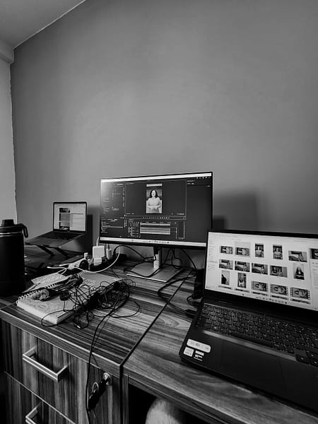 a desk with a laptop and a monitor on it macos mission control open windows desktop organization.jpg