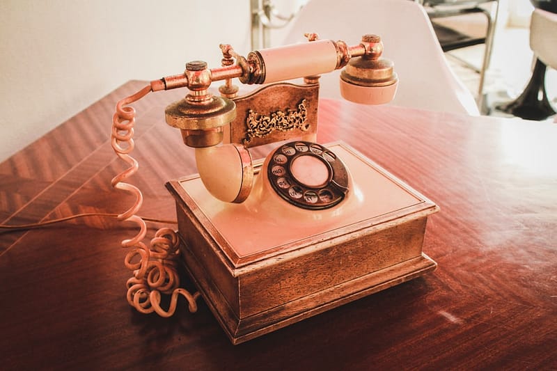 white and brown rotary telephone on brown wooden table android phone messages transfer backup restore.jpg