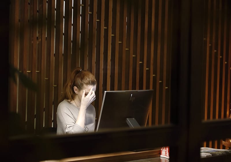 a woman sitting in front of a laptop computer windows task manager smss exe.jpg