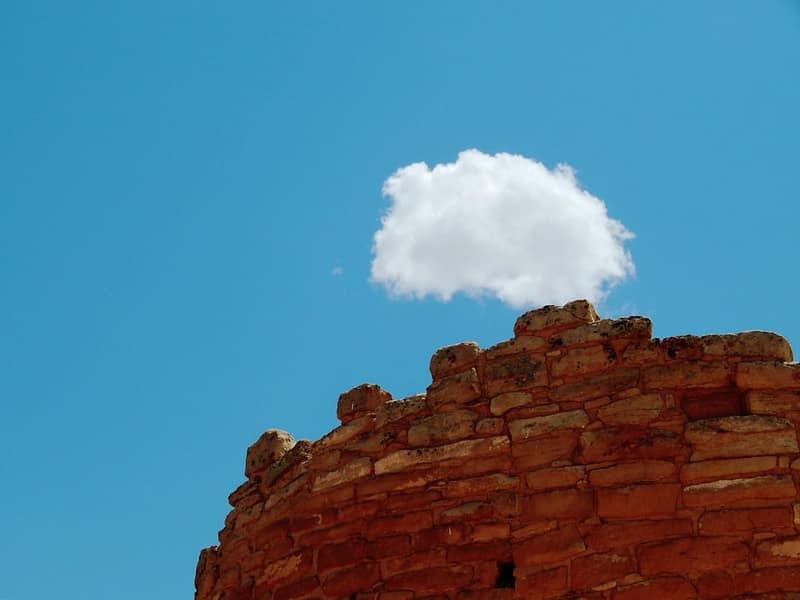 a single cloud floats above ancient stone ruins aws rds database failover cloud reliability.jpg