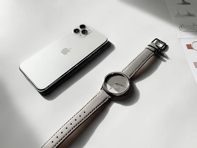 silver iphone 6 beside silver apple watch with brown leather strap apple watch privacy concern wearable device 2.jpg