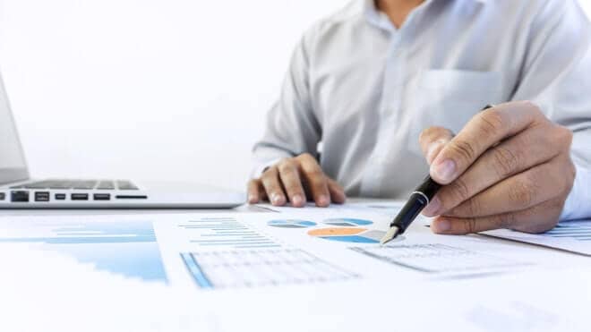 businessman accountant working audit and calculating expense financial data on graph documents 660w15.jpg